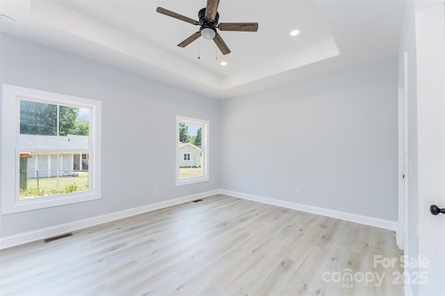 309 Walker St, Kannapolis, NC 28081 - unfurnished room featuring light wood finished floors, plenty of natural light, recessed lighting, a raised ceiling, and ceiling fan