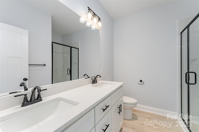 309 Walker St, Kannapolis, NC 28081 - full bathroom featuring a marble finish shower, double vanity, and wood finished floors