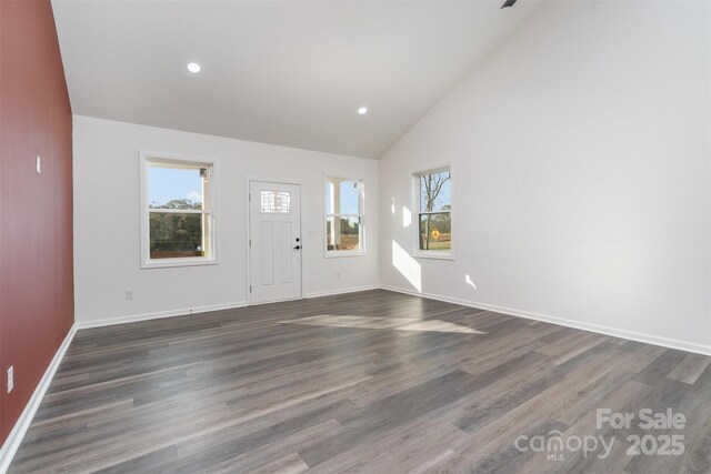 foyer featuring healthy amount of natural light, dark wood-style flooring, baseboards, high vaulted ceiling, and recessed lighting