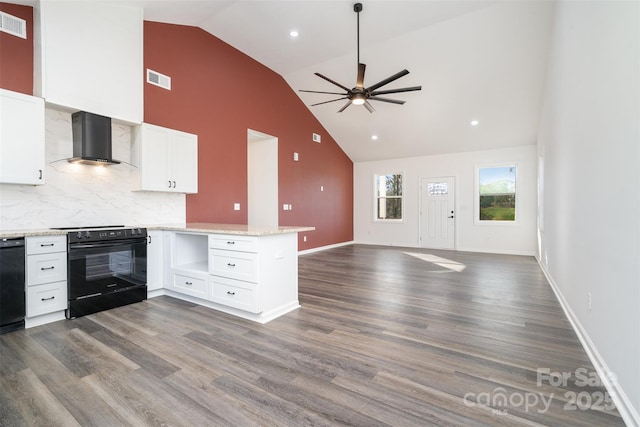 kitchen featuring wall chimney range hood, black electric range oven, a peninsula, high vaulted ceiling, and a ceiling fan
