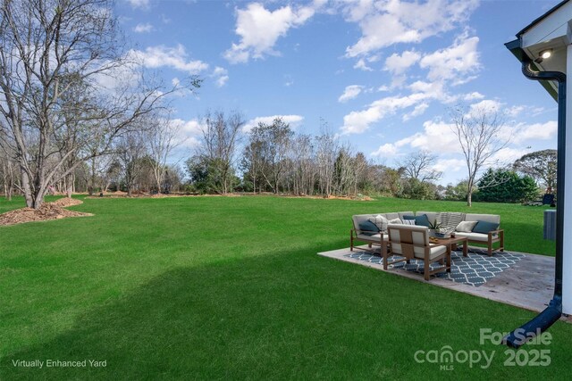 view of grassy yard with outdoor lounge area and a patio