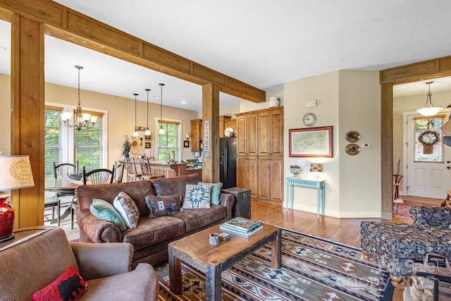 85 Southshore Dr Unit A2, Tuckasegee, NC 28783 - living area featuring a chandelier, light wood finished floors, beamed ceiling, and baseboards