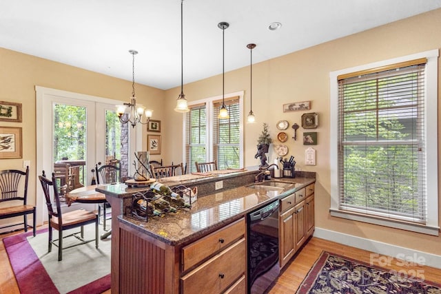 85 Southshore Dr Unit A2, Tuckasegee, NC 28783 - kitchen with a sink, black dishwasher, light wood-style floors, a peninsula, and a chandelier