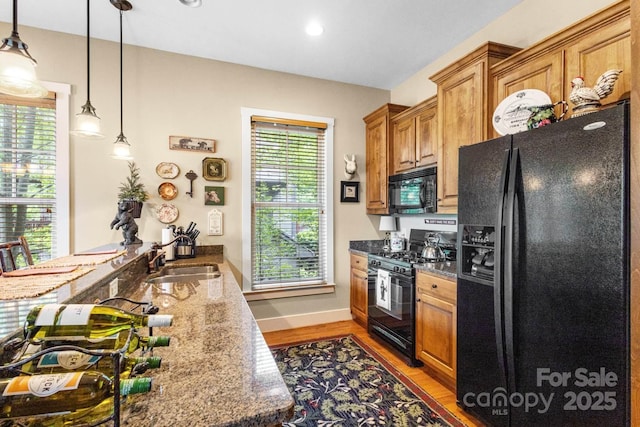 85 Southshore Dr Unit A2, Tuckasegee, NC 28783 - kitchen with black appliances, a sink, light wood-style floors, brown cabinetry, and recessed lighting