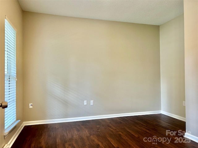 4504 Bellmore Ct, Charlotte, NC 28269 - empty room with dark wood-style floors and plenty of natural light