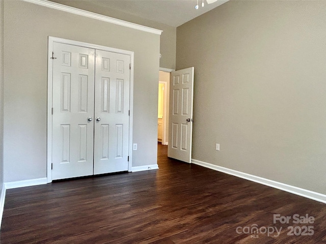 4504 Bellmore Ct, Charlotte, NC 28269 - unfurnished bedroom featuring dark wood-style floors, a closet, and ornamental molding
