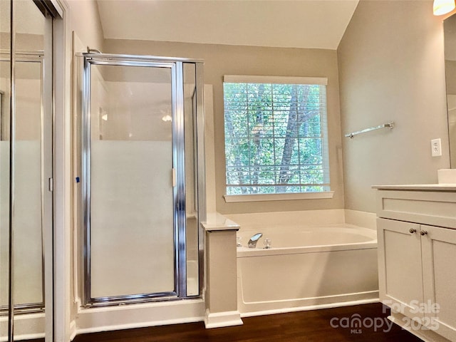 4504 Bellmore Ct, Charlotte, NC 28269 - bathroom with a shower stall, vanity, a bath, and wood finished floors