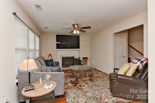 7007 Broad Leaf Ct, Indian Trail, NC 28079 - living room featuring a ceiling fan and a glass covered fireplace