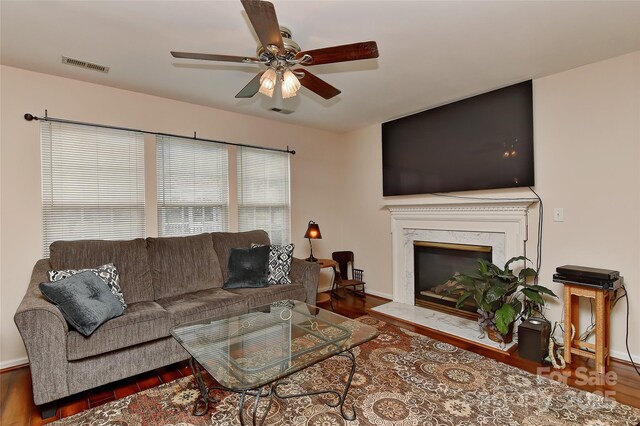 7007 Broad Leaf Ct, Indian Trail, NC 28079 - living room featuring a ceiling fan, wood finished floors, baseboards, and a premium fireplace