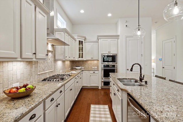 7913 Waverly Walk Ave, Charlotte, NC 28277 - kitchen with appliances with stainless steel finishes, a sink, dark wood finished floors, tasteful backsplash, and glass insert cabinets