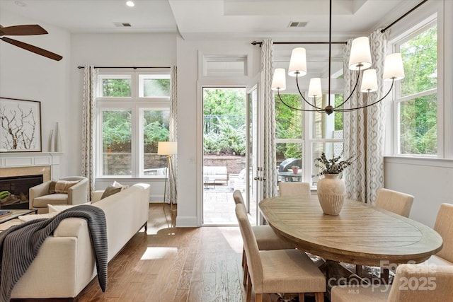 7913 Waverly Walk Ave, Charlotte, NC 28277 - dining area with wood finished floors, ceiling fan, a chandelier, a premium fireplace, and recessed lighting