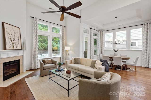 7913 Waverly Walk Ave, Charlotte, NC 28277 - living room with healthy amount of natural light, a chandelier, wood finished floors, a fireplace with flush hearth, and crown molding
