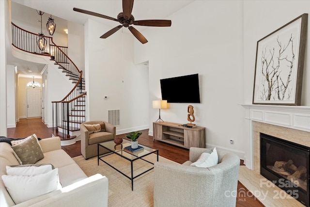 7913 Waverly Walk Ave, Charlotte, NC 28277 - living area featuring a towering ceiling, stairs, baseboards, wood finished floors, and a chandelier