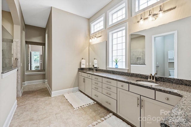 7913 Waverly Walk Ave, Charlotte, NC 28277 - full bath with baseboards, tiled shower, double vanity, and healthy amount of natural light