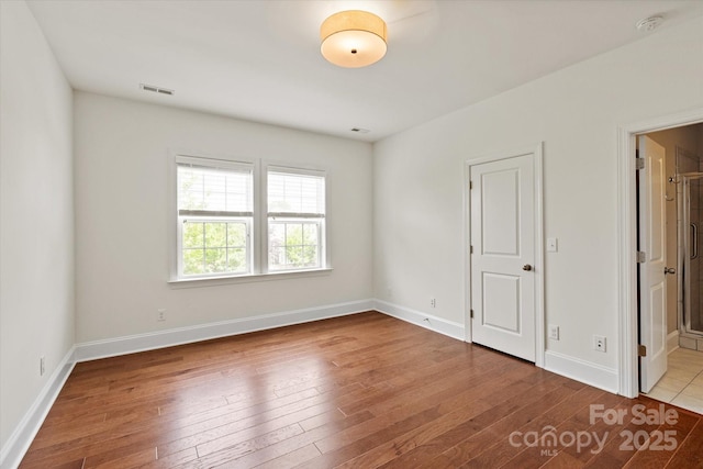 7913 Waverly Walk Ave, Charlotte, NC 28277 - unfurnished bedroom featuring hardwood / wood-style flooring, baseboards, and ensuite bathroom