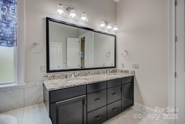 14503 Crest Ct, Charlotte, NC 28278 - bathroom with double vanity, marble look tiles, and a bathtub