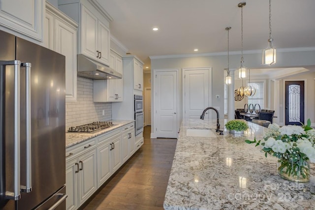14503 Crest Ct, Charlotte, NC 28278 - kitchen featuring appliances with stainless steel finishes, crown molding, tasteful backsplash, light stone countertops, and a chandelier