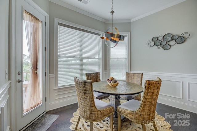 14503 Crest Ct, Charlotte, NC 28278 - dining room featuring a decorative wall, dark wood-style flooring, ornamental molding, and wainscoting