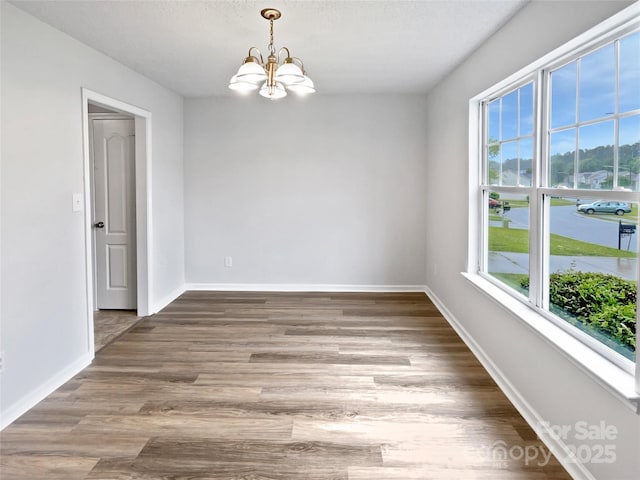 752 Raindrops Rd, Gastonia, NC 28054 - unfurnished room with a chandelier, wood finished floors, baseboards, and a water view