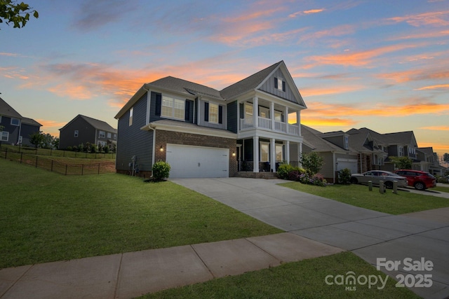 1001 Linn Cv, Waxhaw, NC 28173 - view of front facade featuring a balcony, concrete driveway, an attached garage, brick siding, and board and batten siding