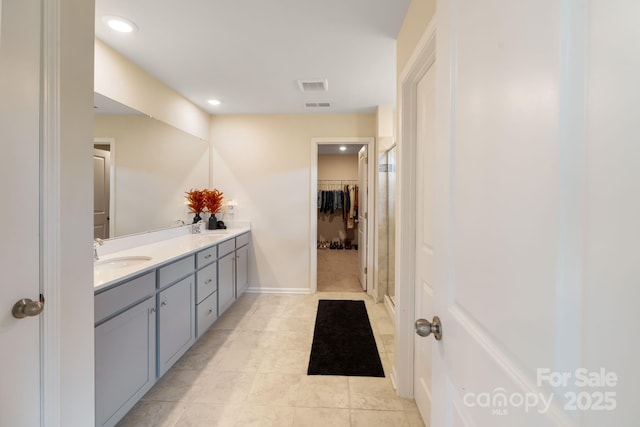 1001 Linn Cv, Waxhaw, NC 28173 - bathroom featuring double vanity, recessed lighting, a walk in closet, baseboards, and tile patterned flooring