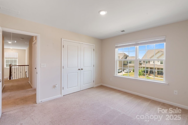 1001 Linn Cv, Waxhaw, NC 28173 - unfurnished bedroom featuring light colored carpet, baseboards, and a closet