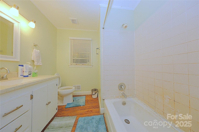 3016 Boston Ave, Charlotte, NC 28212 - bathroom featuring wood finished floors, toilet, vanity, crown molding, and shower / bath combination
