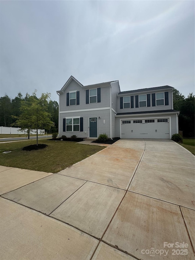 view of front of home with concrete driveway, a front yard, and a garage
