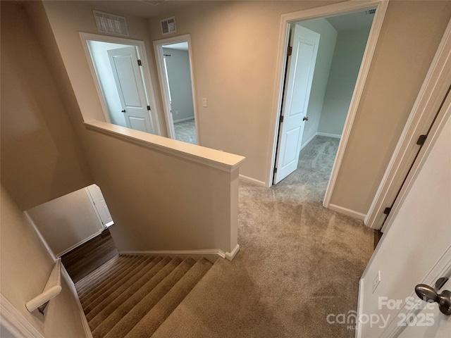 stairs with carpet flooring and baseboards