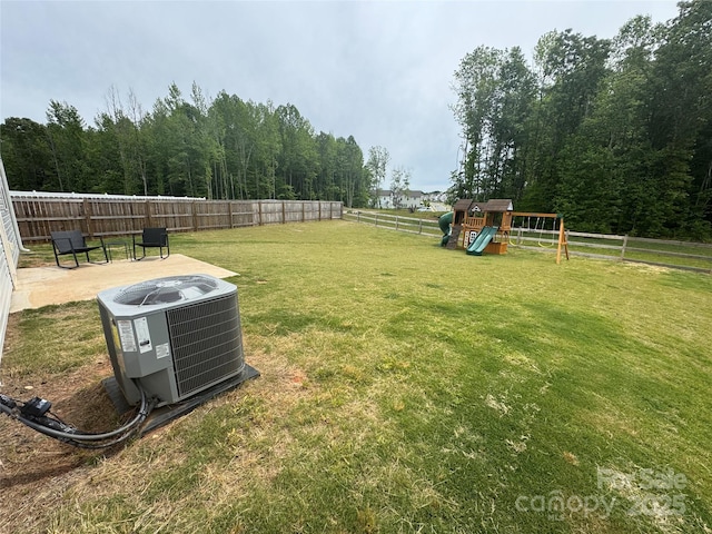 view of yard featuring a playground and central AC