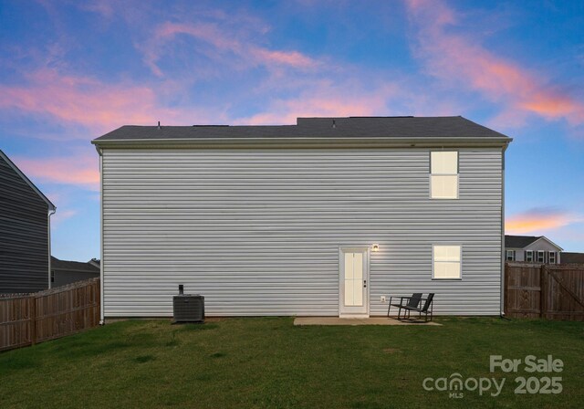 110 Browband St, Troutman, NC 28166 - back of house at dusk featuring central AC unit