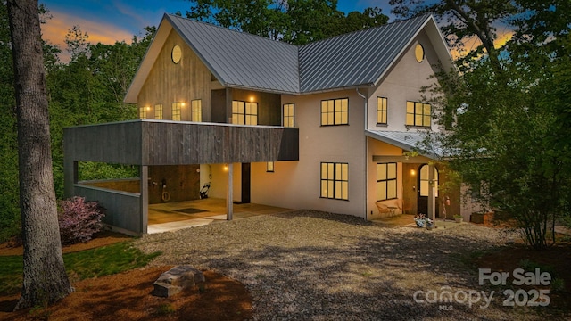 7 Bee Balm Way, Asheville, NC 28804 - back of property with a standing seam roof, stucco siding, metal roof, and a patio