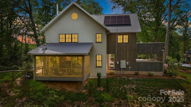 7 Bee Balm Way, Asheville, NC 28804 - rear view of property featuring a sunroom, solar panels, metal roof, and a standing seam roof