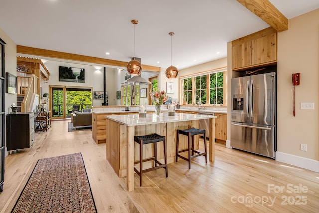 7 Bee Balm Way, Asheville, NC 28804 - kitchen with stainless steel appliances, light wood finished floors, a kitchen bar, recessed lighting, and light brown cabinetry