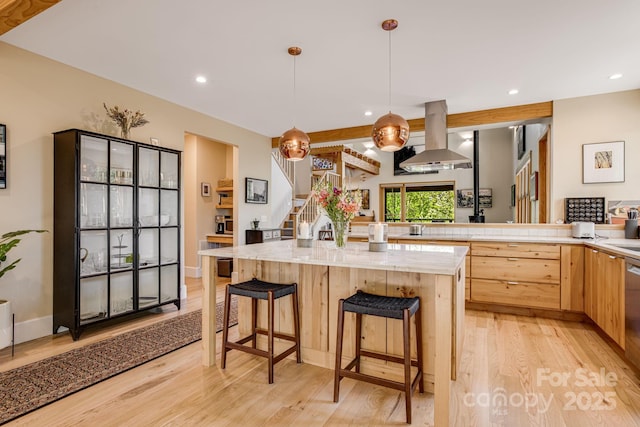 7 Bee Balm Way, Asheville, NC 28804 - kitchen with exhaust hood, light wood-style flooring, light brown cabinetry, recessed lighting, and a kitchen bar