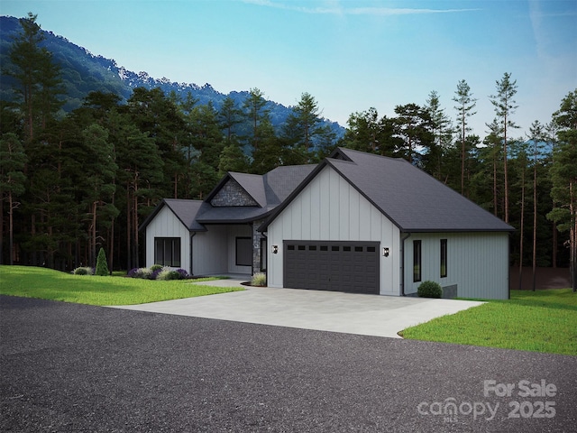 modern farmhouse style home featuring a garage, a front lawn, concrete driveway, and board and batten siding