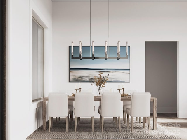 dining space featuring wood finished floors and baseboards