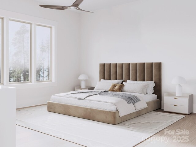 bedroom featuring multiple windows, wood finished floors, and a ceiling fan