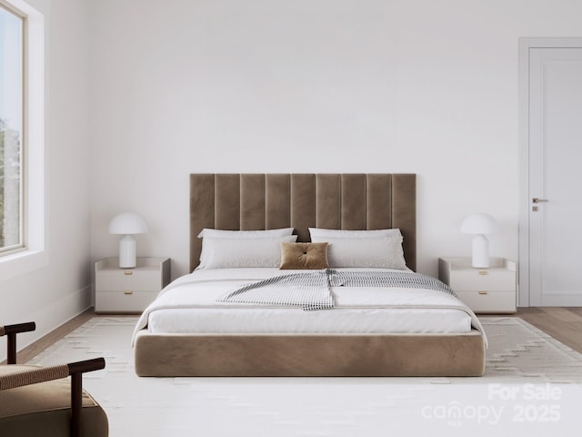 bedroom featuring baseboards and light wood-type flooring