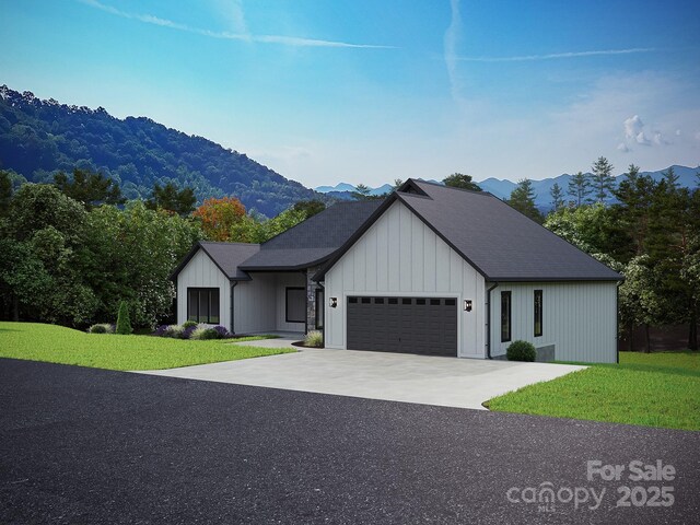 51 Bridgeway Dr Unit 12, Candler, NC 28715 - modern farmhouse with an attached garage, a mountain view, a front lawn, concrete driveway, and board and batten siding