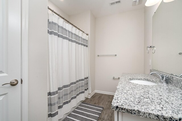 829 River Park Rd, Belmont, NC 28012 - full bath with wood finished floors, baseboards, a shower with curtain, and vanity