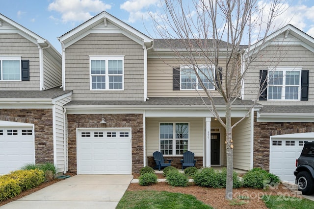 829 River Park Rd, Belmont, NC 28012 - view of front of house with covered porch, a garage, stone siding, driveway, and roof with shingles