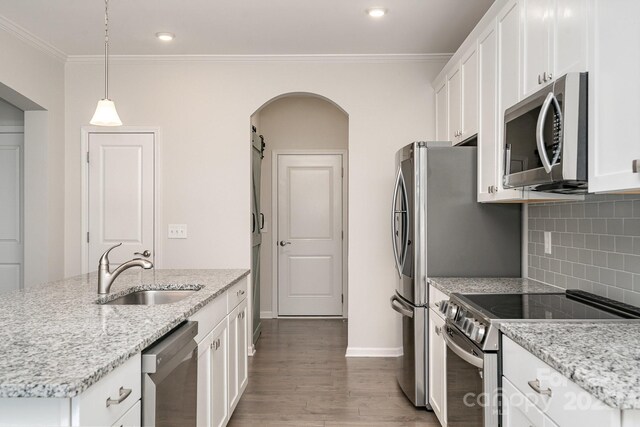 829 River Park Rd, Belmont, NC 28012 - kitchen with stainless steel appliances, a sink, arched walkways, wood finished floors, and white cabinets