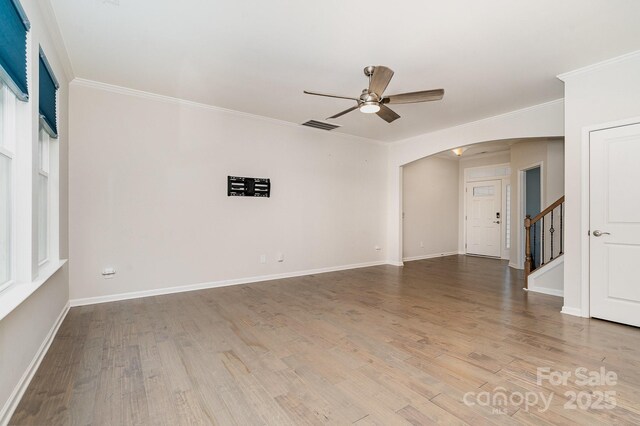 829 River Park Rd, Belmont, NC 28012 - unfurnished room featuring arched walkways, a ceiling fan, crown molding, wood finished floors, and baseboards