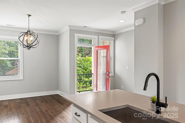 1162 E 36th St, Charlotte, NC 28205 - kitchen featuring a sink, plenty of natural light, dark wood-type flooring, white cabinetry, and ornamental molding