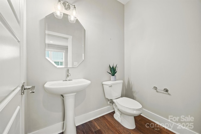 1162 E 36th St, Charlotte, NC 28205 - bathroom with toilet, baseboards, and wood finished floors