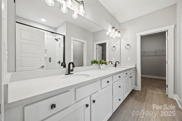 1162 E 36th St, Charlotte, NC 28205 - full bath with double vanity, a shower stall, a spacious closet, and baseboards