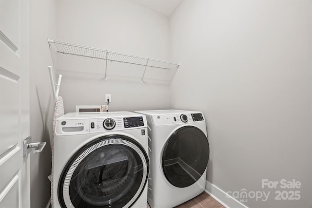 1162 E 36th St, Charlotte, NC 28205 - laundry room with washer and clothes dryer, baseboards, and tile patterned flooring