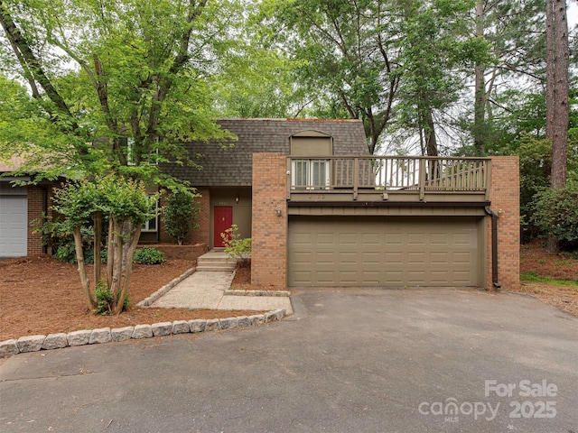 4025 Woodfox Dr, Charlotte, NC 28277 - front of property featuring driveway, brick siding, mansard roof, a shingled roof, and a balcony