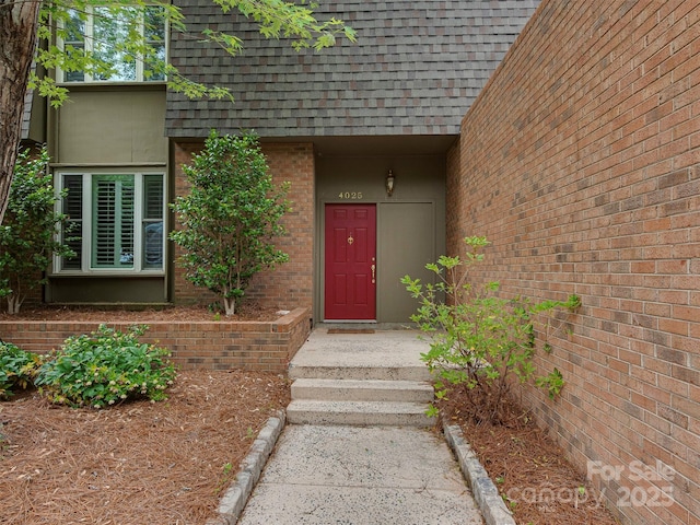4025 Woodfox Dr, Charlotte, NC 28277 - doorway to property featuring roof with shingles, brick siding, and mansard roof